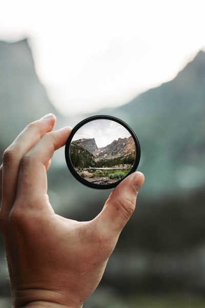 A stunning mountain landscape magnified through a handheld lens highlighting exploration and adventure.